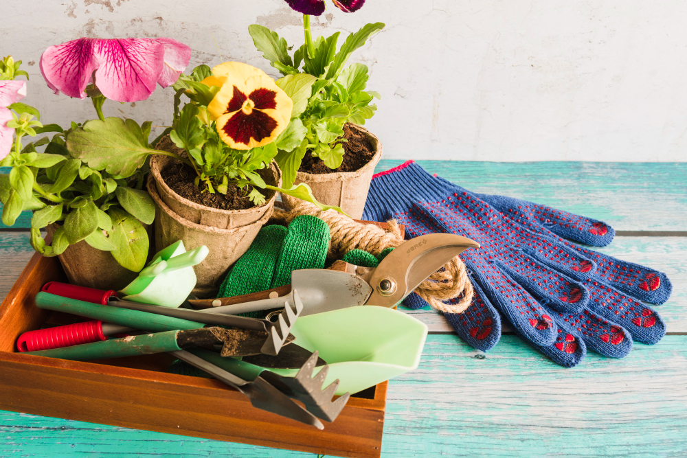 gardening-equipment-with-peat-pots-plant-gardening-gloves-wooden-table
